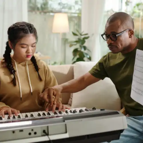 A picture of a child playing a Yamaha PSR keyboard as part of the Annual Tuition Package at Templesprings in Grays