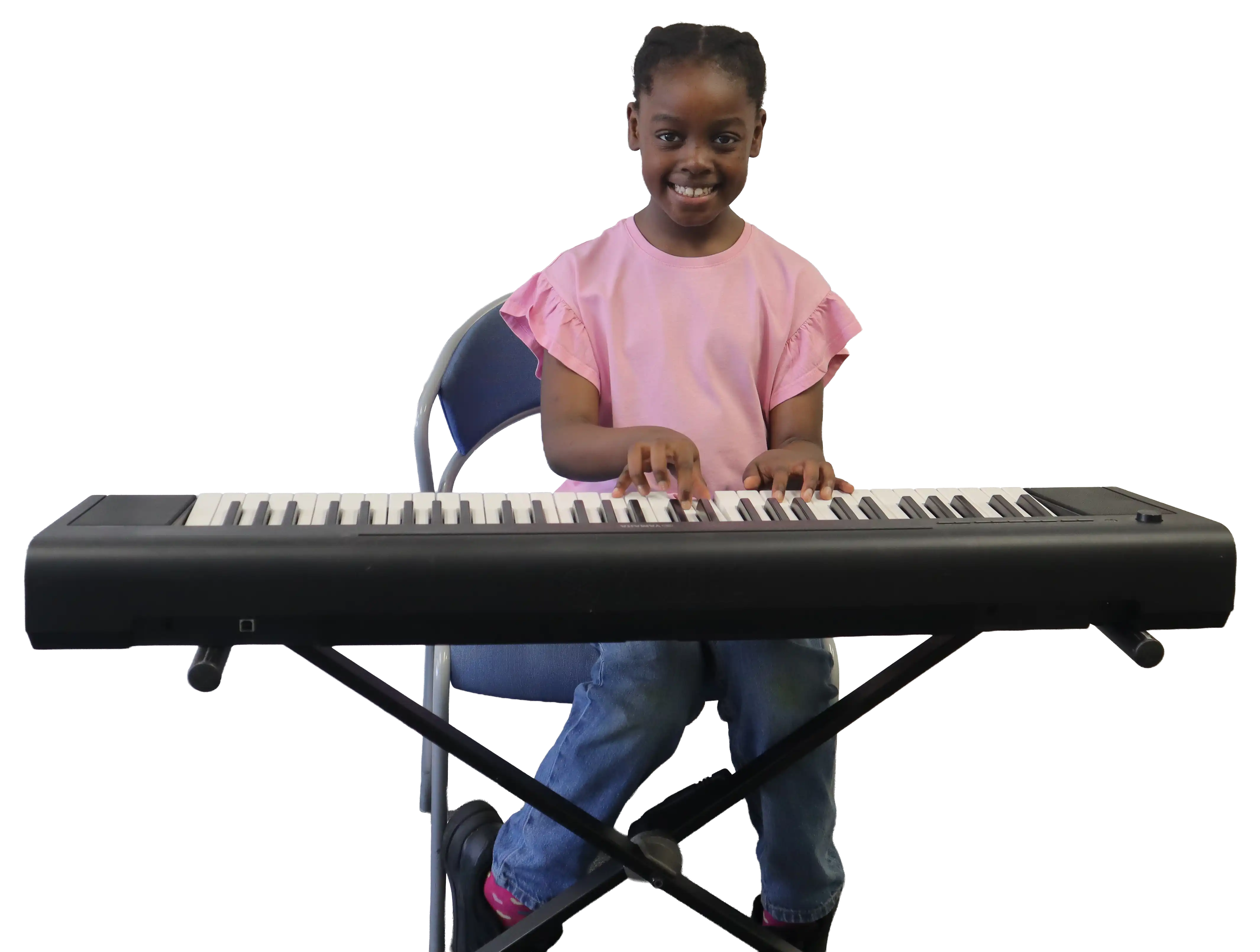 Child enjoying herself playing the piano as part of our music tuition in Grays